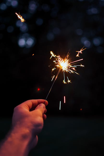 Hand holding a sparkler representing bright ideas